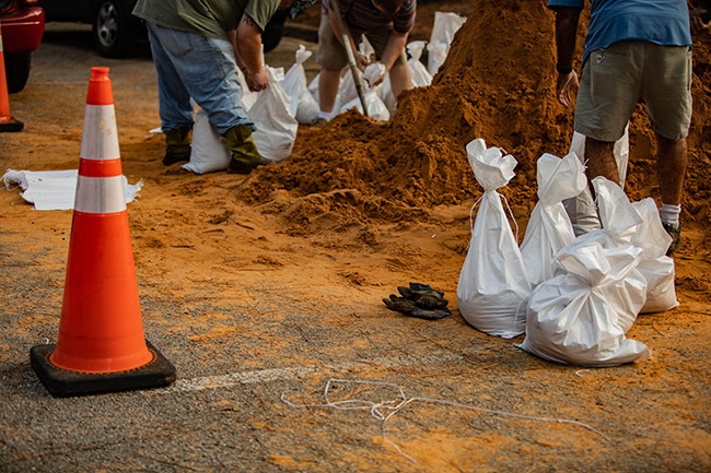 people filling sandbags at a City preparedness site