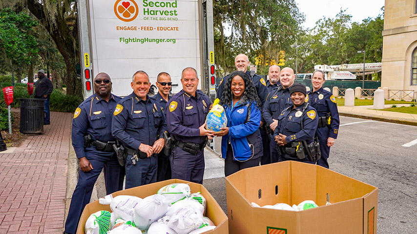 TPD officers distribute food at a food bank event.